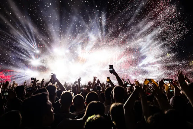 Confetti fireworks above the crowd on music festival.